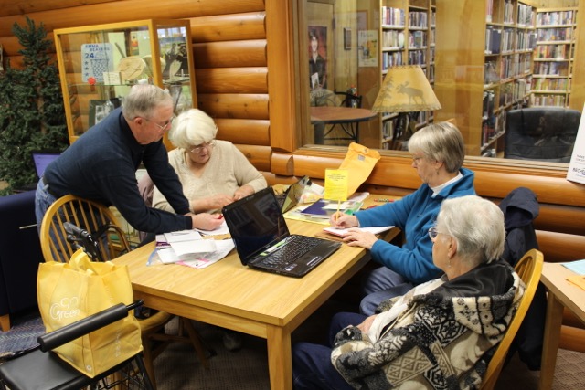 Part of the
                                                      Obituary Project
                                                      team works on the
                                                      scans.